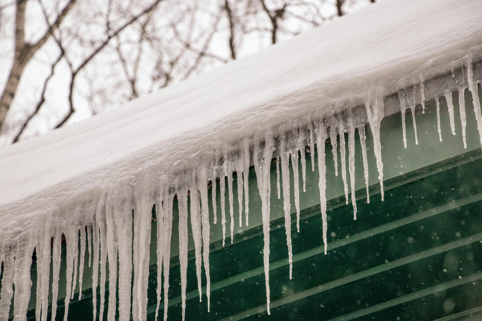 Ice-covered Oklahoma City rooftop after a winter storm with icicles hanging from gutters